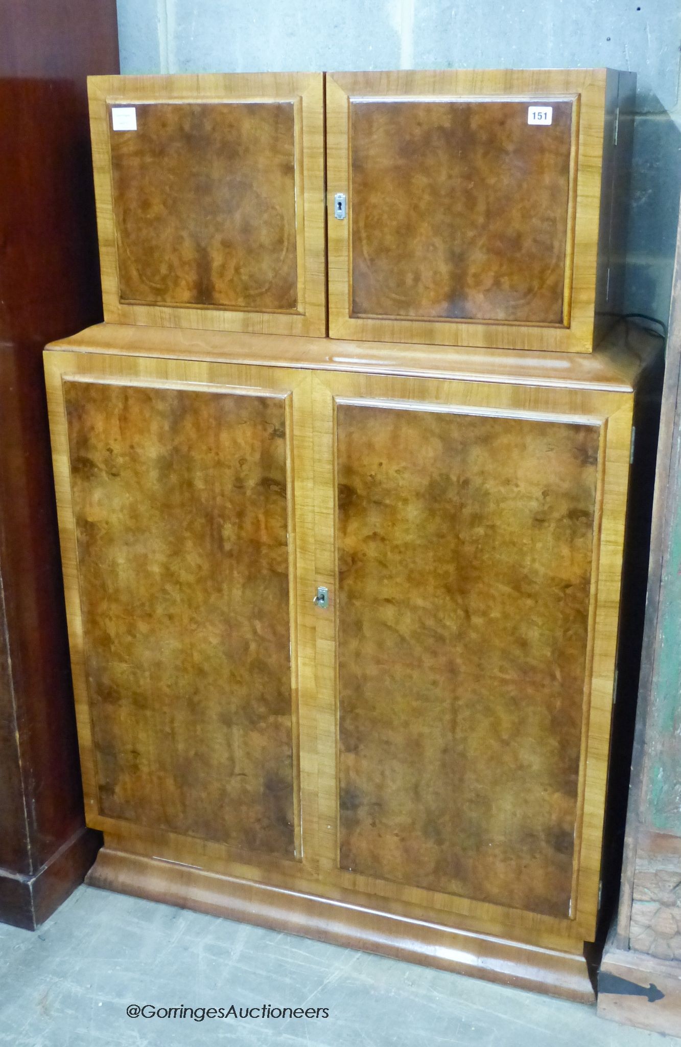 An Art Deco burr walnut veneered cocktail cabinet, length 94cm, depth 39cm, height 144cm